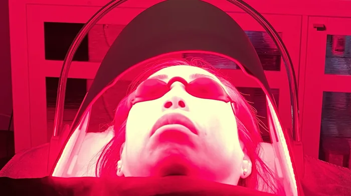 Client receiving red light therapy under the LED panel at Altru Radiance in Murray, Utah